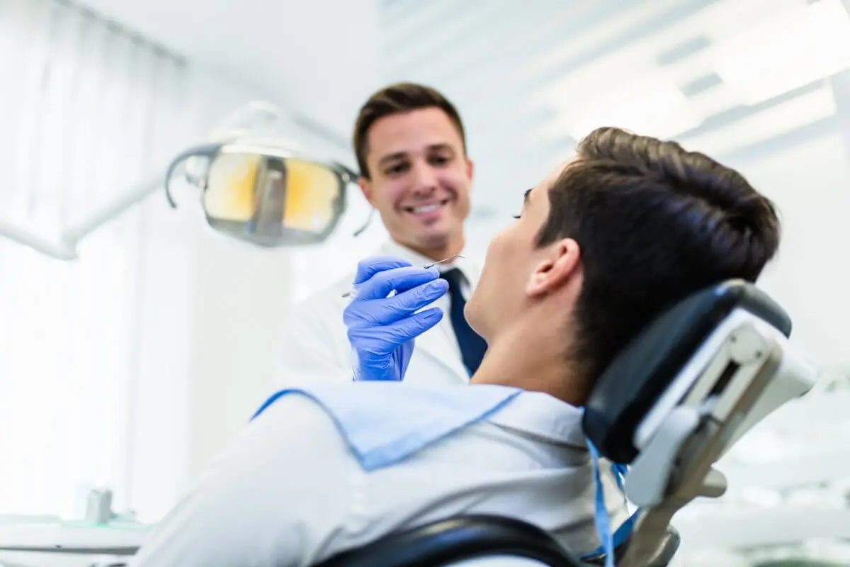 Dentist Fixing White Spots On Patient's Teeth