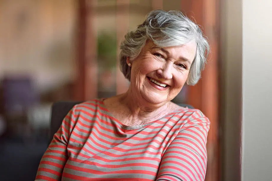 mature woman smiling in a striped shirt