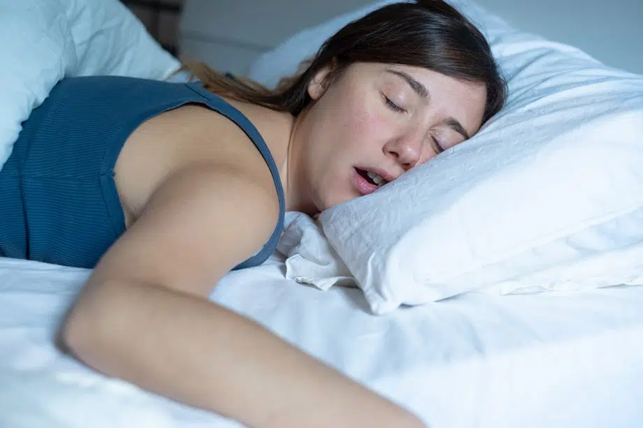woman sleeps on stomach with mouth open